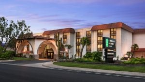 hotel with plants and trees around it